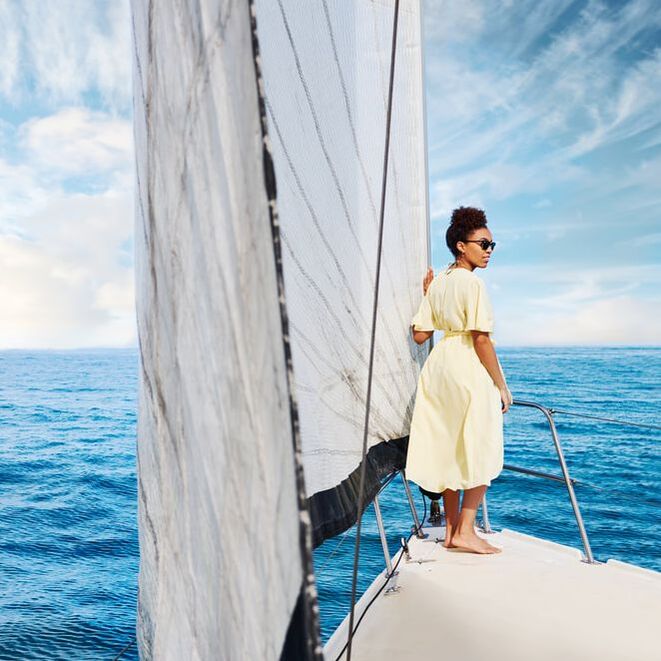 Woman on prow of sailboat