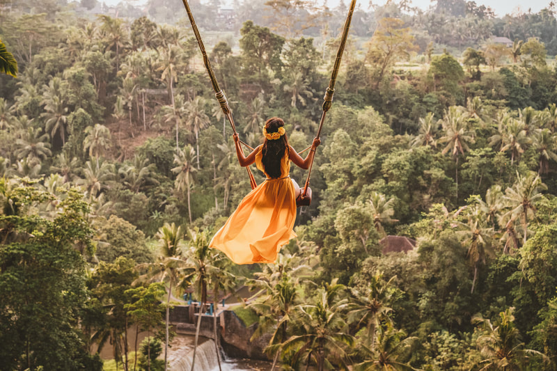 Woman swinging over Thai jungle