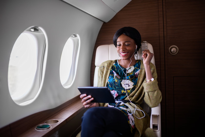 Smiling woman on private jet